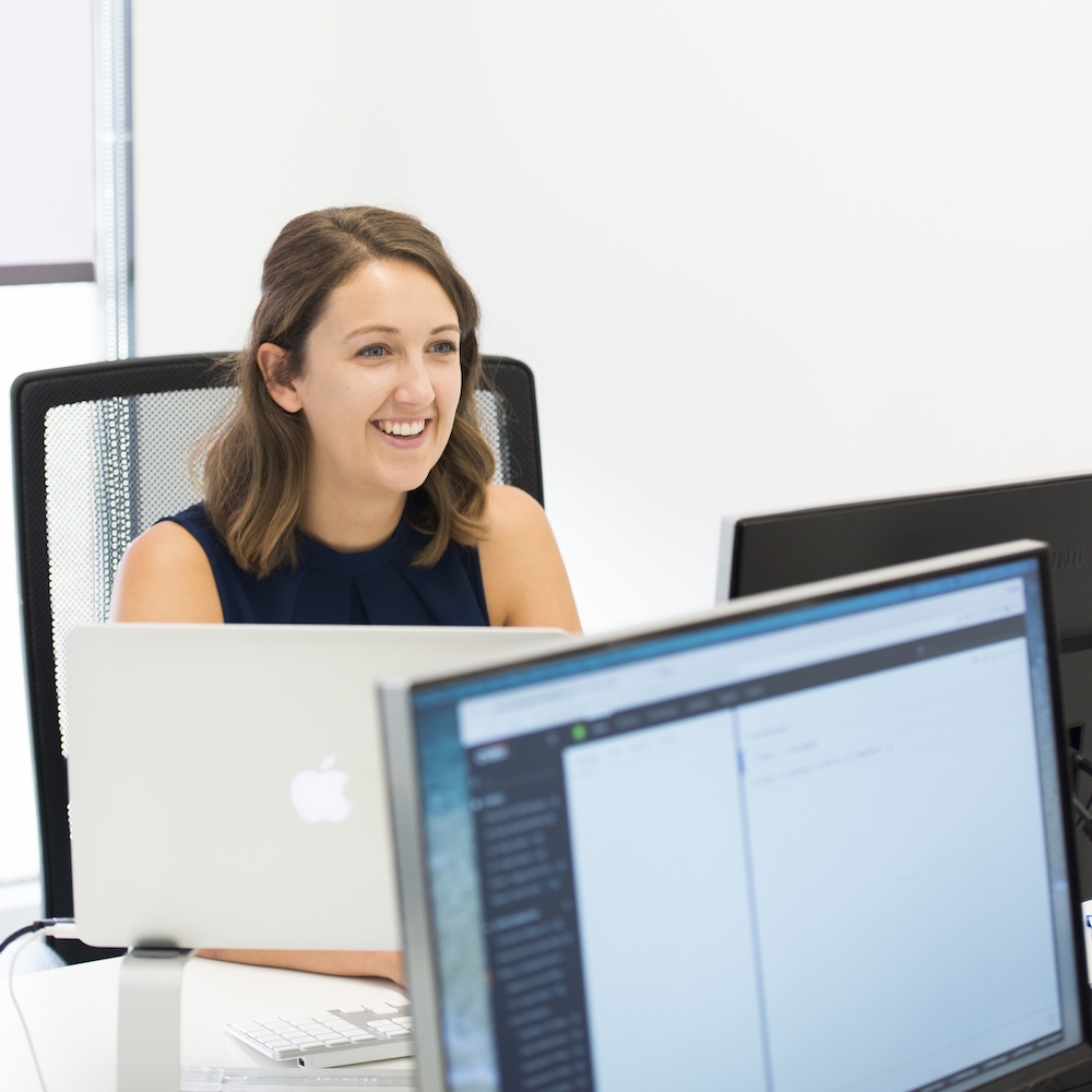 Consultant looks over the top of a computer monitor